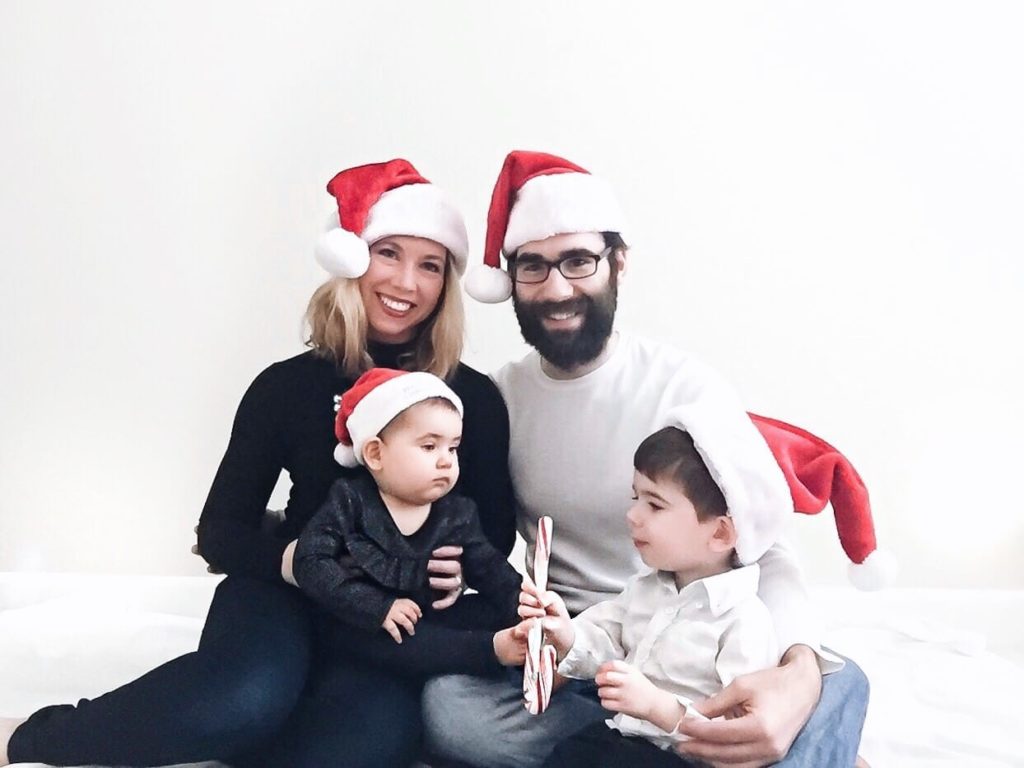 mom dad kids wearing santa hat family christmas photo
