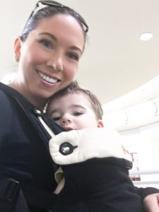 mom and baby in baby carrier at airport