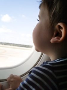 little boy looking out airplane window