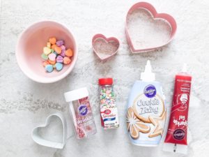 candy hearts, icing, heart-shaped cookie cutter for decorating super easy valentine desserts for kids