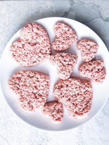 pink heart shaped Rice Krispie Treats on a white plate