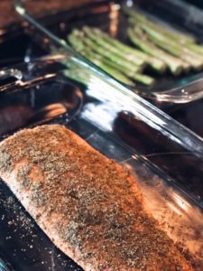 baked salmon recipe in glass dish on a stovetop