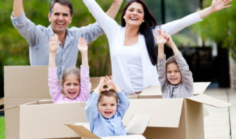 moving-checklist-concept-family-standing-in-moving-boxes