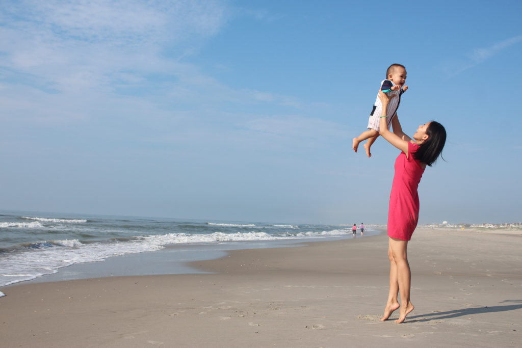 mom-quotes-mom-holding-baby-in-air-at-beach
