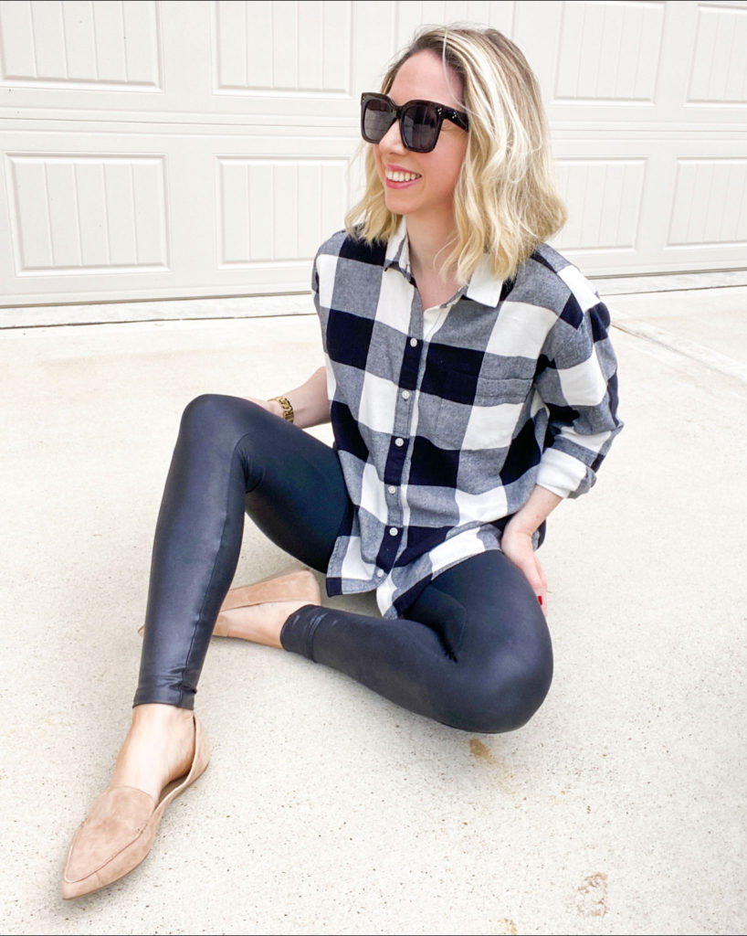 woman-sitting-in-driveway-smiling-wearing-plaid-flannel-shirt-and-spanx-leggings-and-loafers
